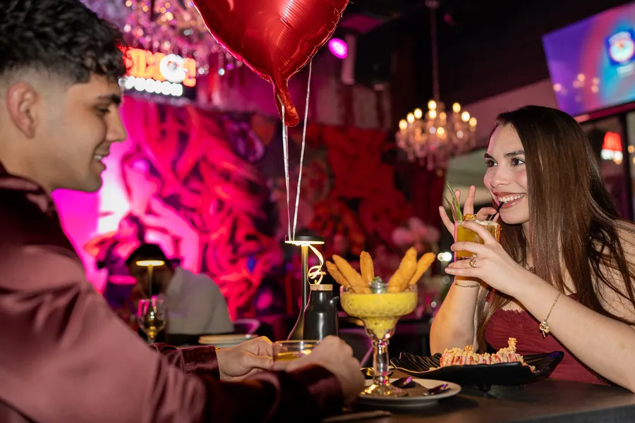 Guests celebrating with cocktails and a heart balloon at KamiKoi Sushi Fusion