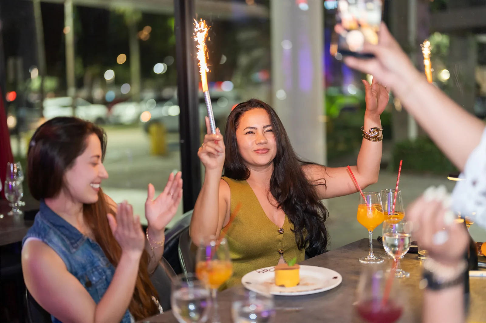 Guests celebrating with cocktails and sparklers at KamiKoi Sushi Fusion in Miami