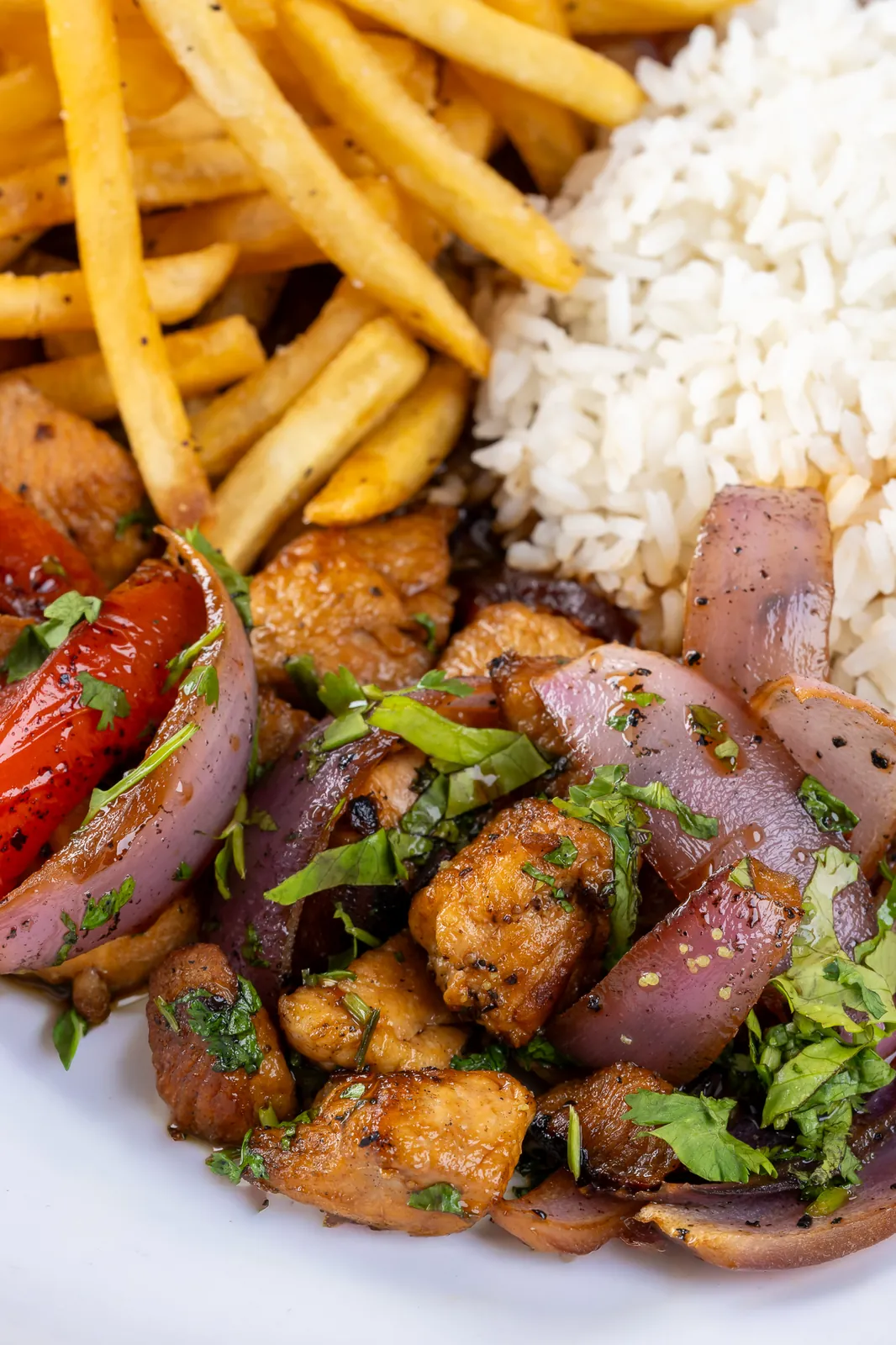 Chicken with sauteed onion and tomato, served with fries and white rice at KamiKoi